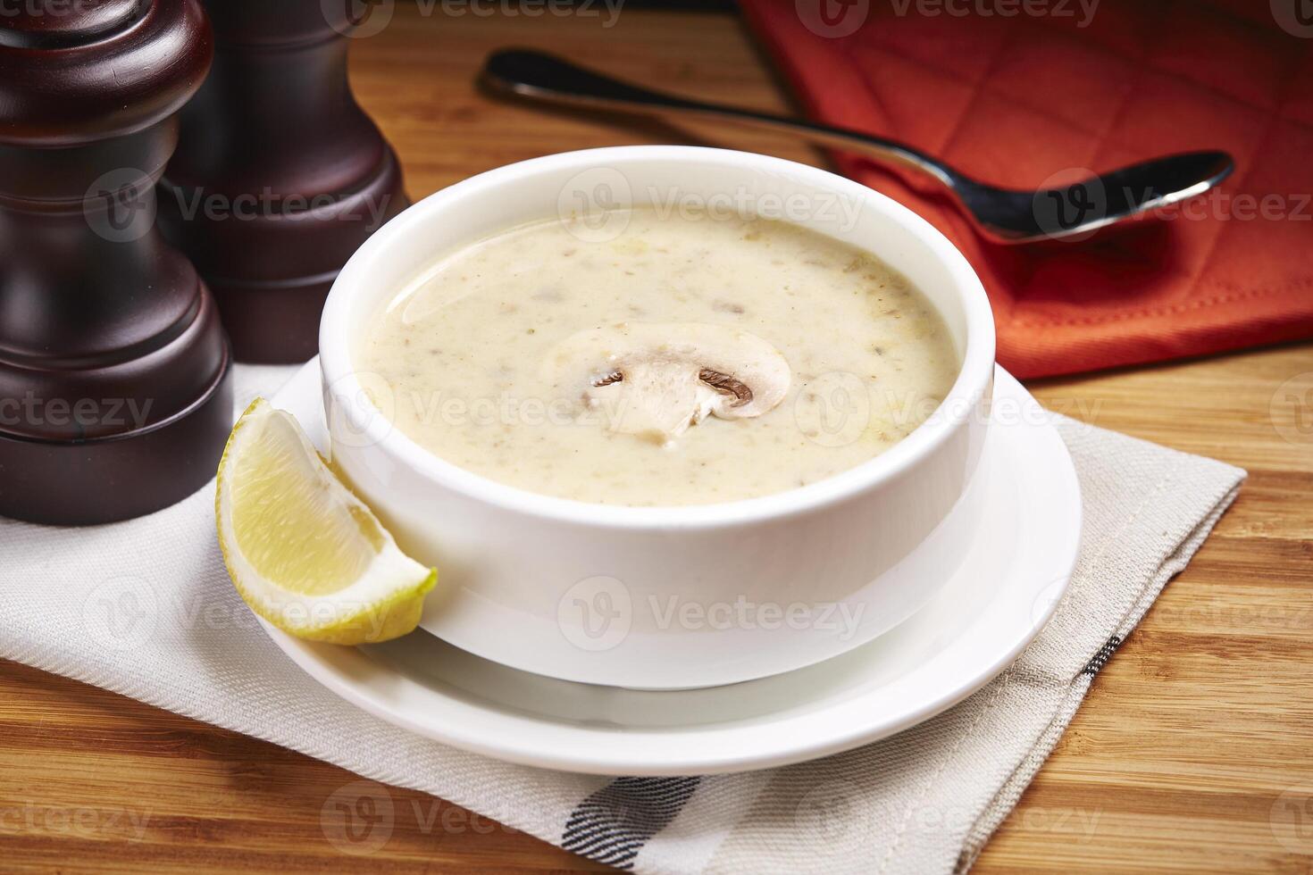 Hot Mushroom Soup with lime slice served in a bowl isolated on table side view of middle east food photo
