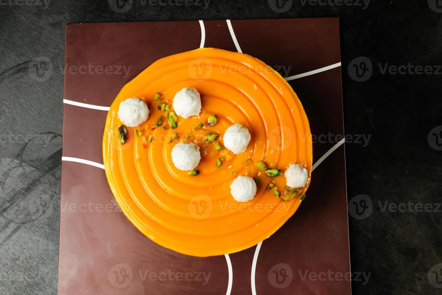 Mango Yogurt Cake topping with pistachio fork and flowers served in plate isolated on napkin top view cafe bake food photo