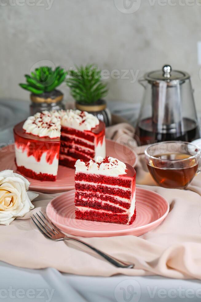 Premium Red Velvet cake and slice include cream, sugar with fork, cup of coffee and pot served on board isolated on napkin side view of cafe food photo