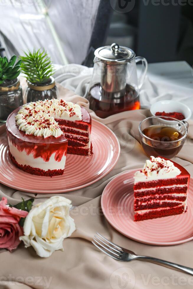 Premium Red Velvet cake and slice include cream, sugar with fork, cup of coffee and pot served on board isolated on napkin side view of cafe food photo