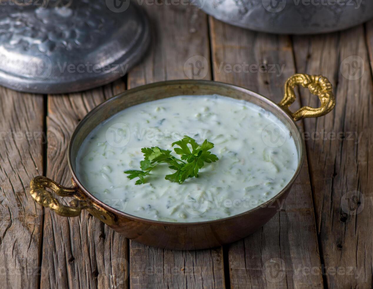 Fresh Cucumber Yoghurt raita served in dish side view on wooden table background photo
