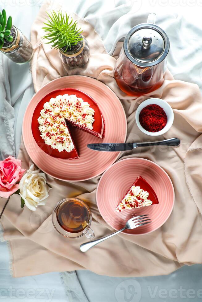 Premium Red Velvet cake and slice include cream, sugar with fork, cup of coffee and pot served on board isolated on napkin top view of cafe food photo