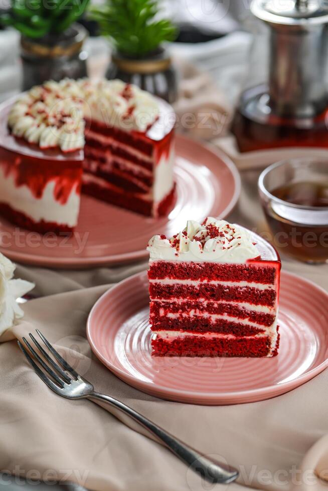 Premium Red Velvet cake and slice include cream, sugar with fork, cup of coffee and pot served on board isolated on napkin side view of cafe food photo