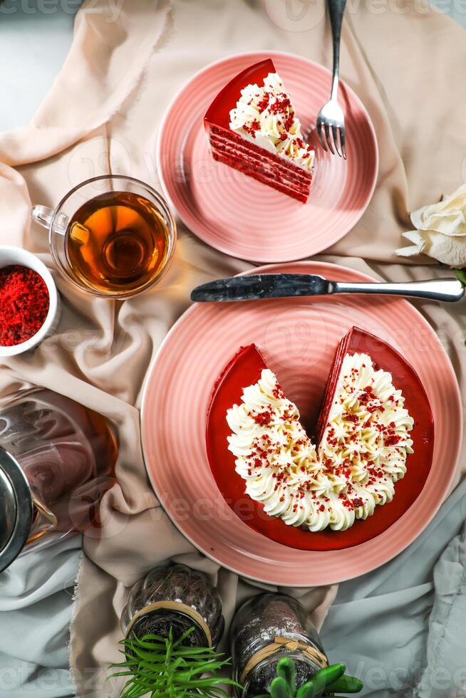 Premium Red Velvet cake and slice include cream, sugar with fork, cup of coffee and pot served on board isolated on napkin top view of cafe food photo