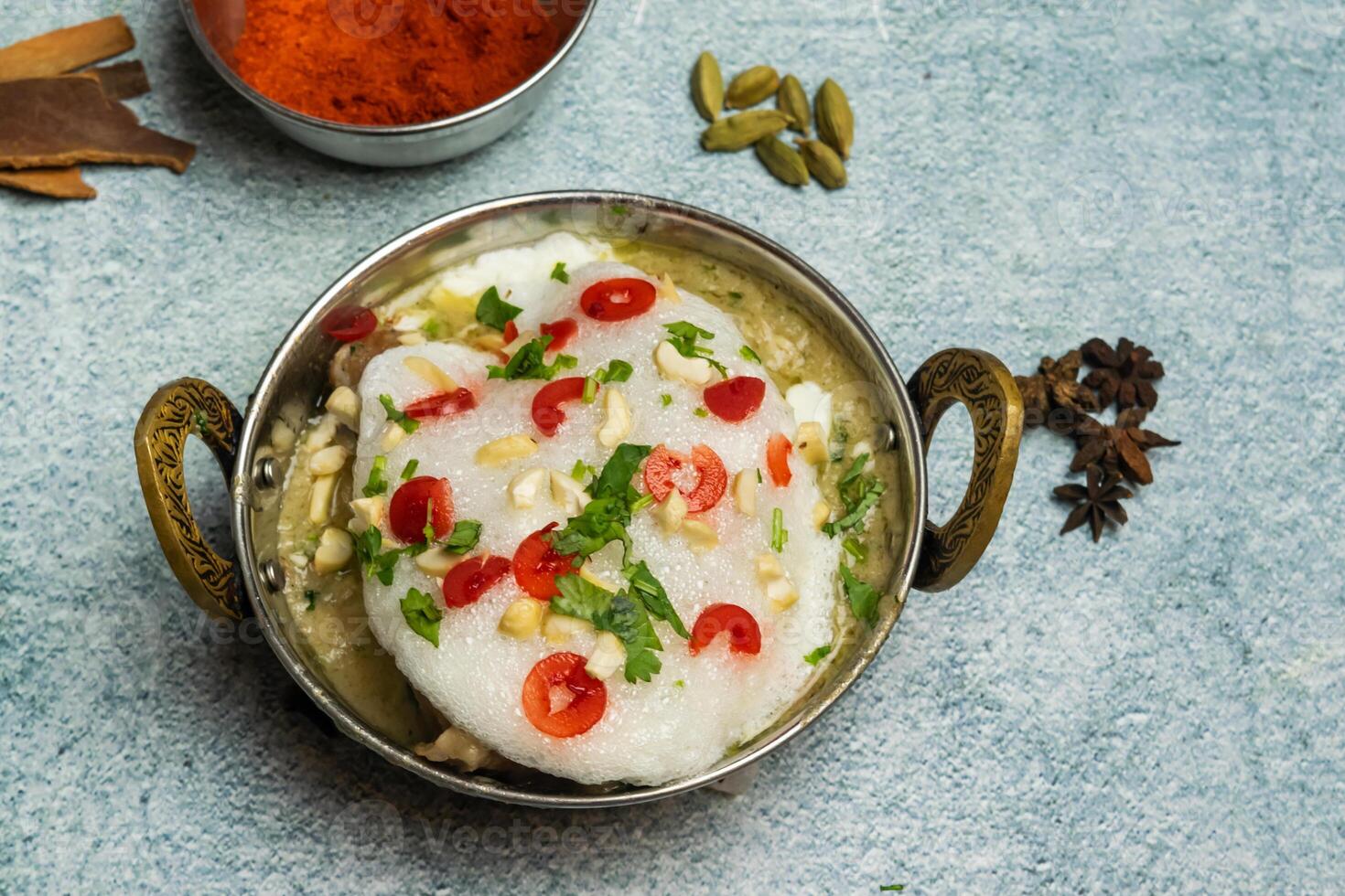 Kashmiri Chicken karahi with onion and chili served in a dish isolated on grey background top view of bangladesh food photo