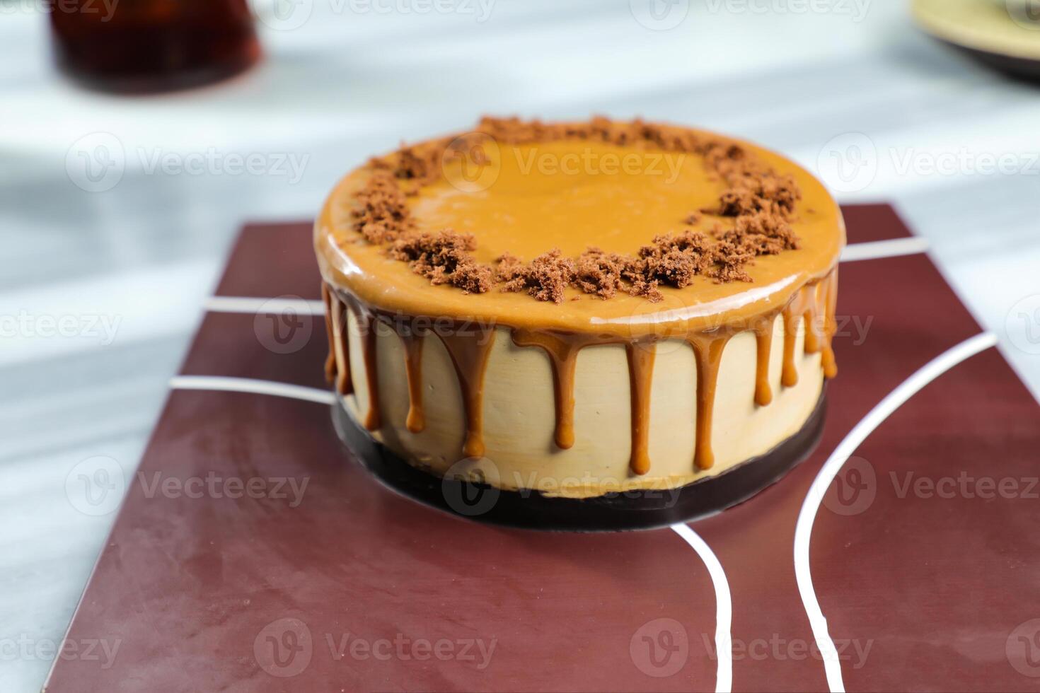 Salted Caramel Blondie cake include chocolate cream, sugar with fork, cup of coffee and pot served on board isolated on napkin side view of cafe food photo