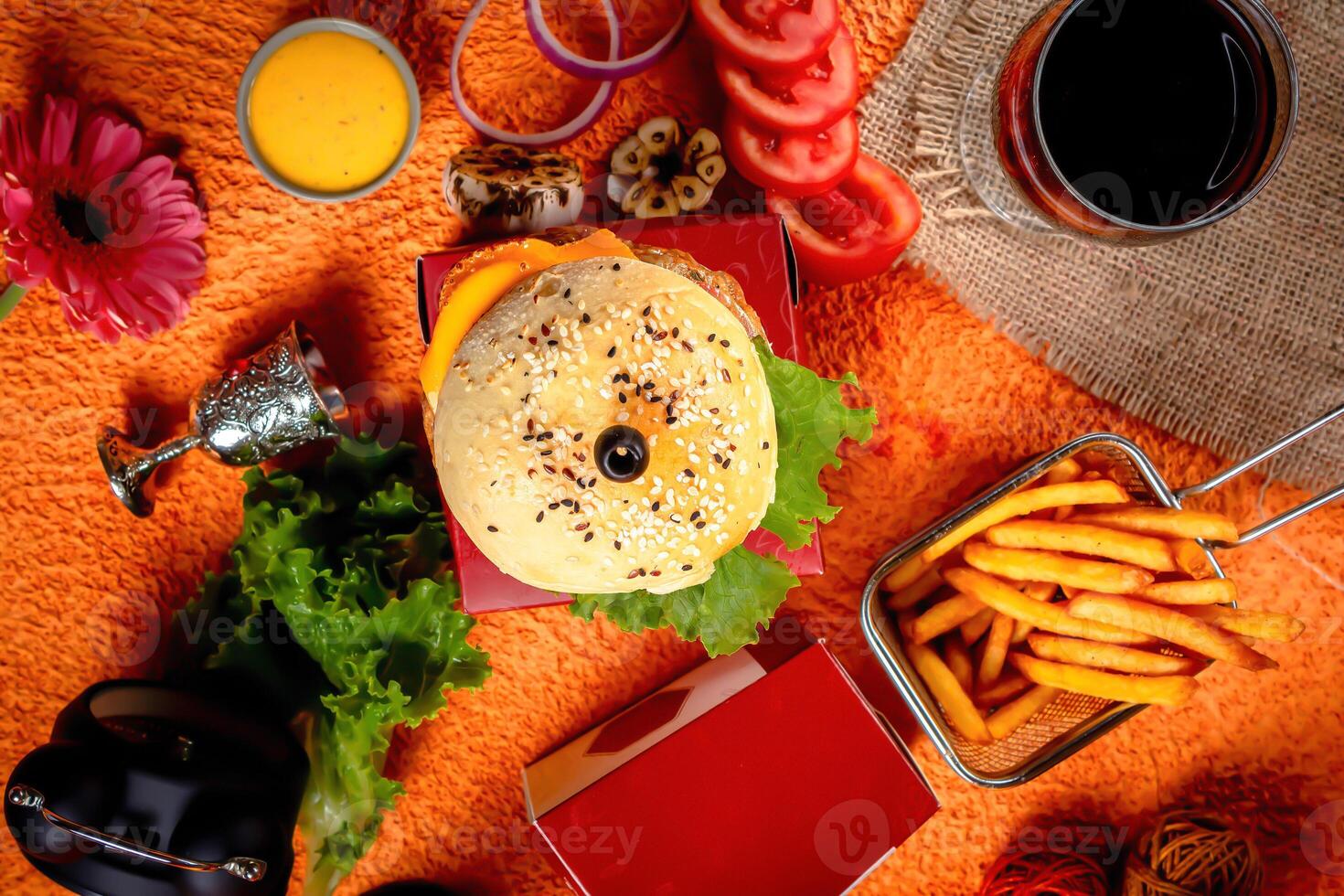 Tongue Twister Beef Naga burger with fries and tomato slice isolated on wooden board side view of american street food photo