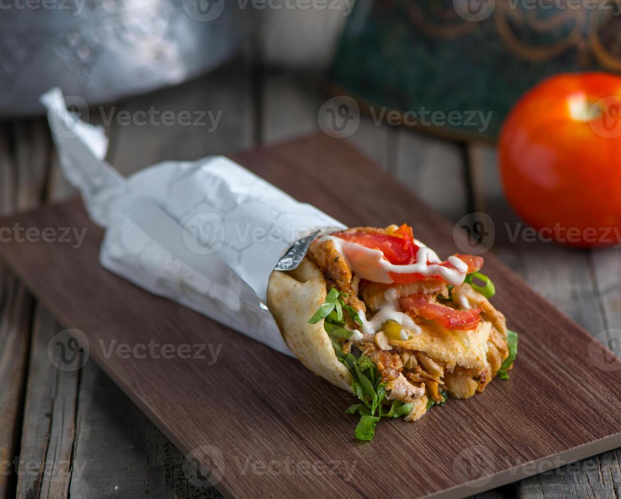 lebanese beef shawarma served in a dish side view on wooden table background photo