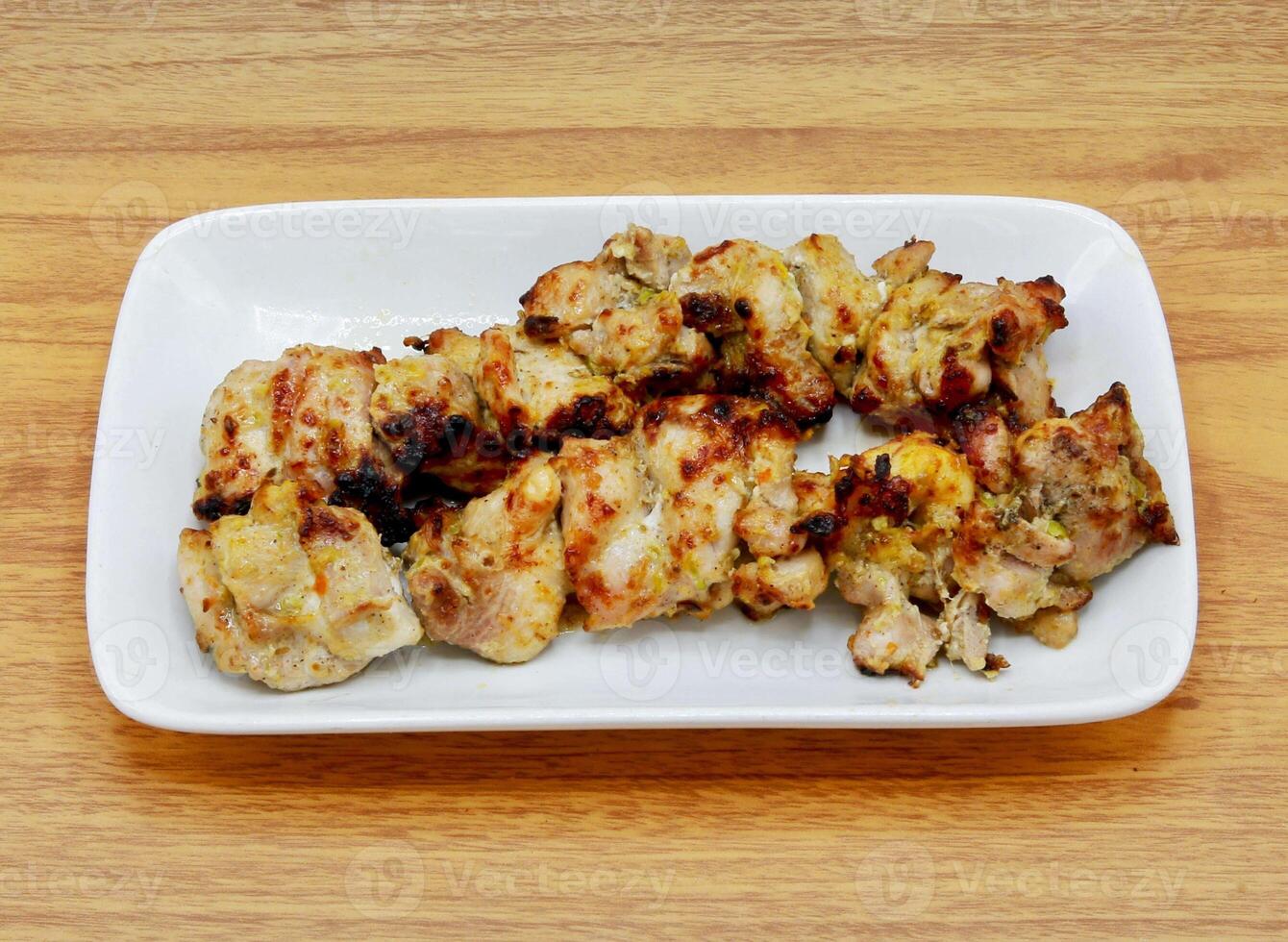 Spicy bbq chicken malai tikka boti kabab served in a dish isolated on grey background side view of indian, pakistani food photo