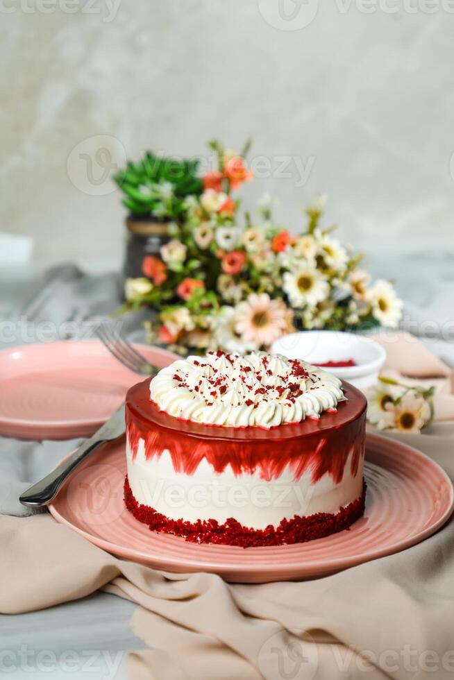 Premium Red Velvet cake include cream, sugar with fork, knife and flowers served in plate isolated on napkin side view of cafe food photo