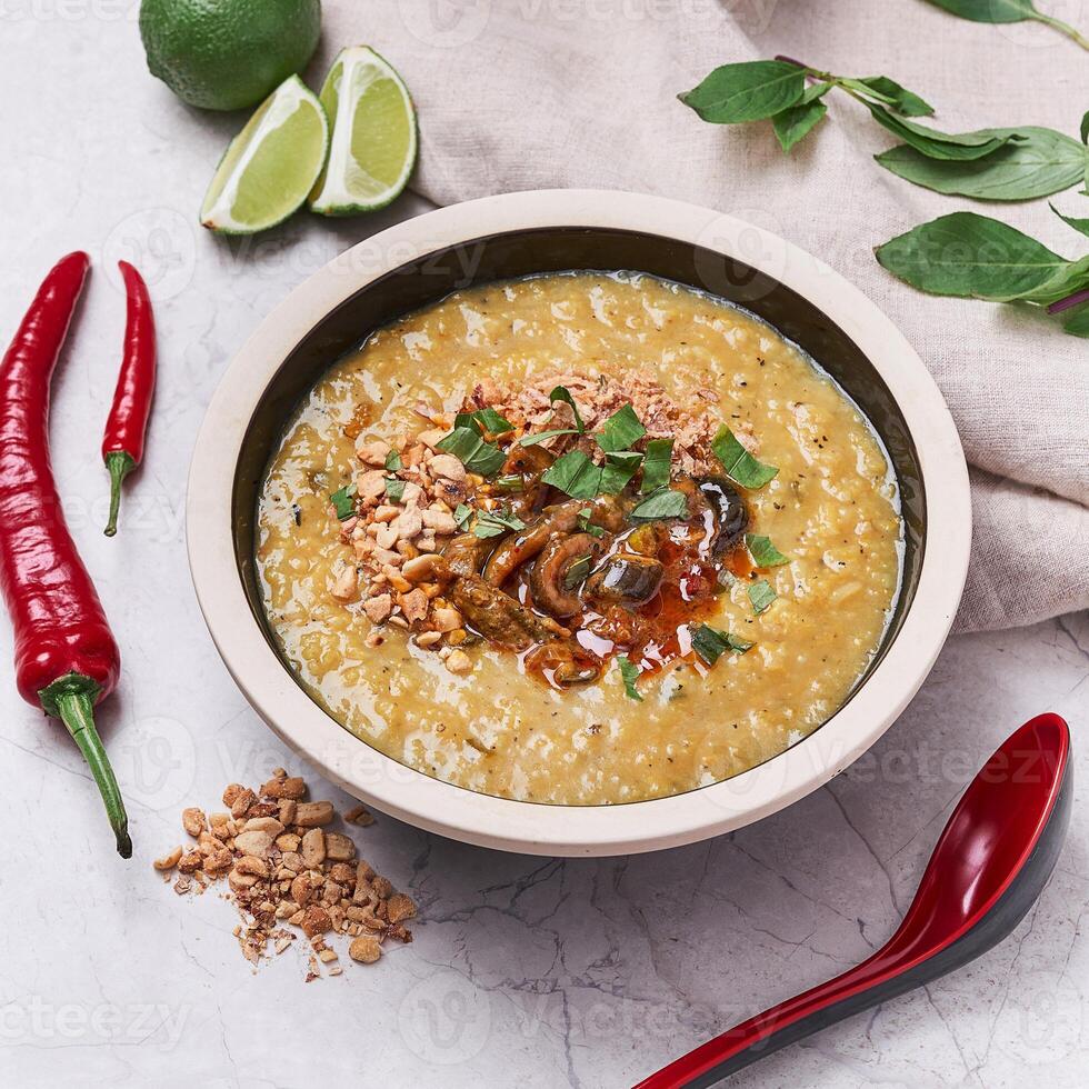 Eel Porridge with lemon and red pepper served in a dish isolated on grey background side view of vietnam food photo