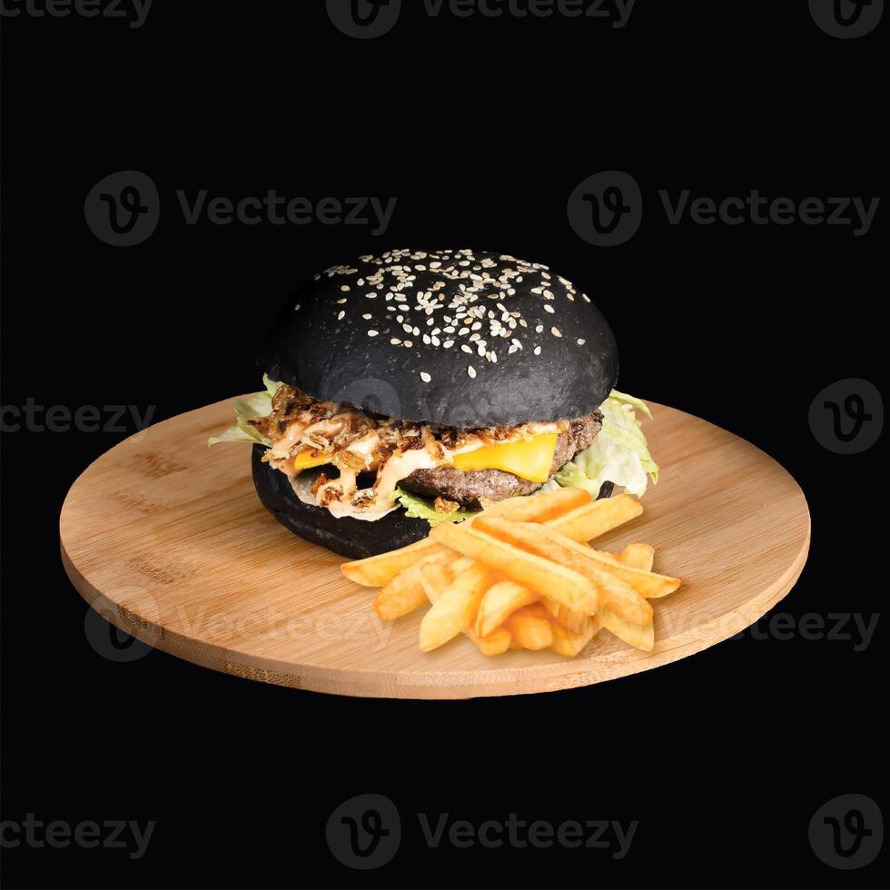 Black Ashes Cheese Burger with french fries served on wooden board side view on black background fast food photo