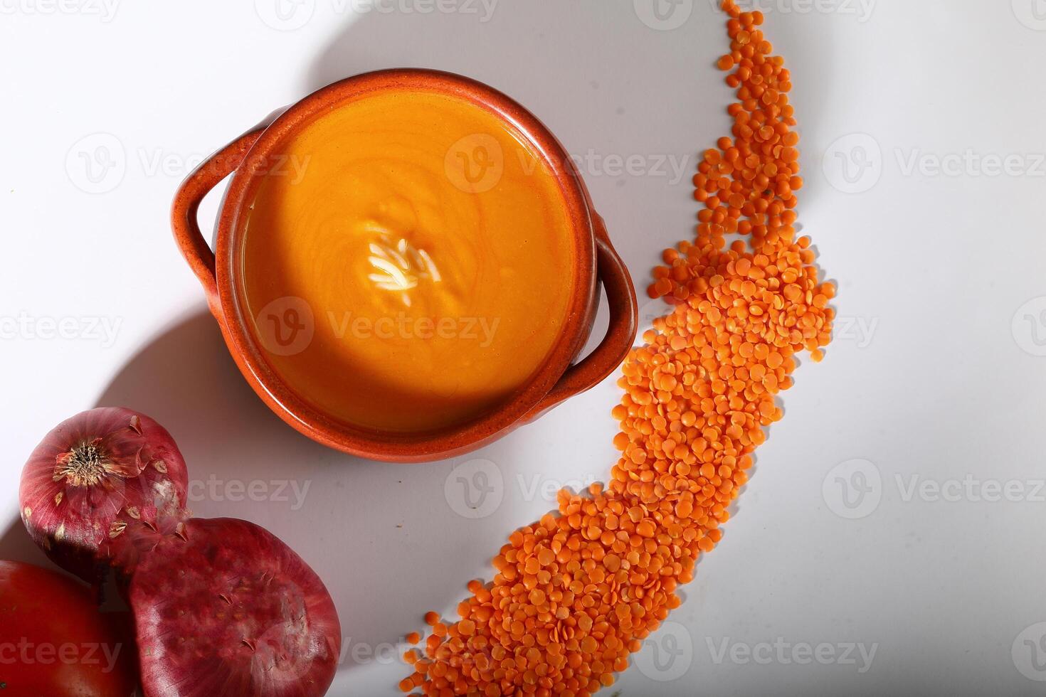 LENTIL SOUP with raw LENTIL, tomato and onion served in a bowl isolated on grey background top view of arabian fastfood photo
