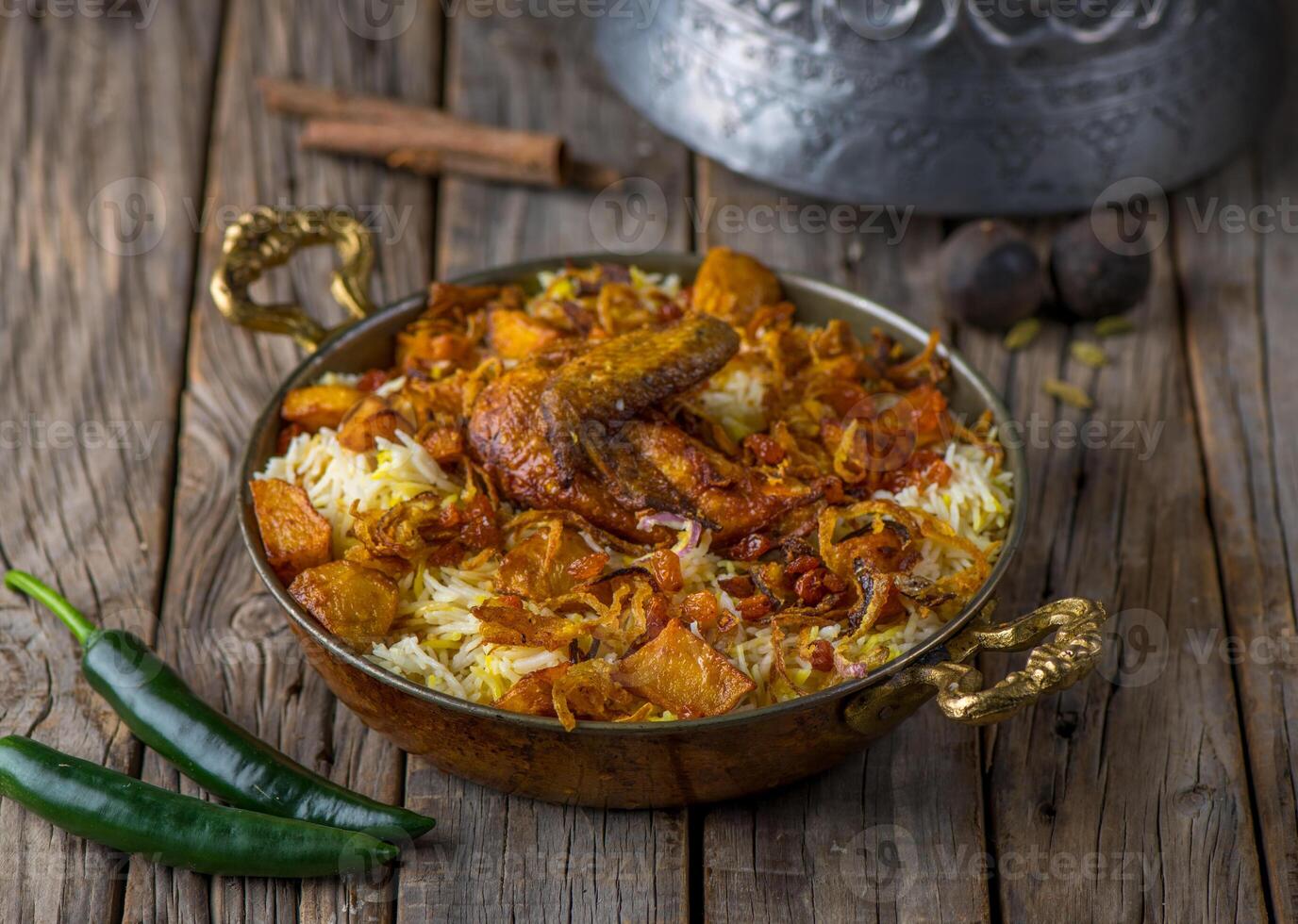Spicy hyderabadi chicken biryani served in dish side view on wooden table background photo