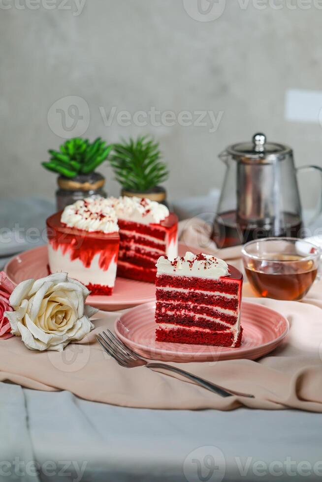 Premium Red Velvet cake and slice include cream, sugar with fork, cup of coffee and pot served on board isolated on napkin side view of cafe food photo