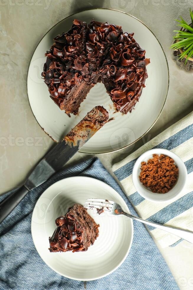 Chocolate Fudge Cake with fork and knife served in plate on food table top view cafe bake dessert photo