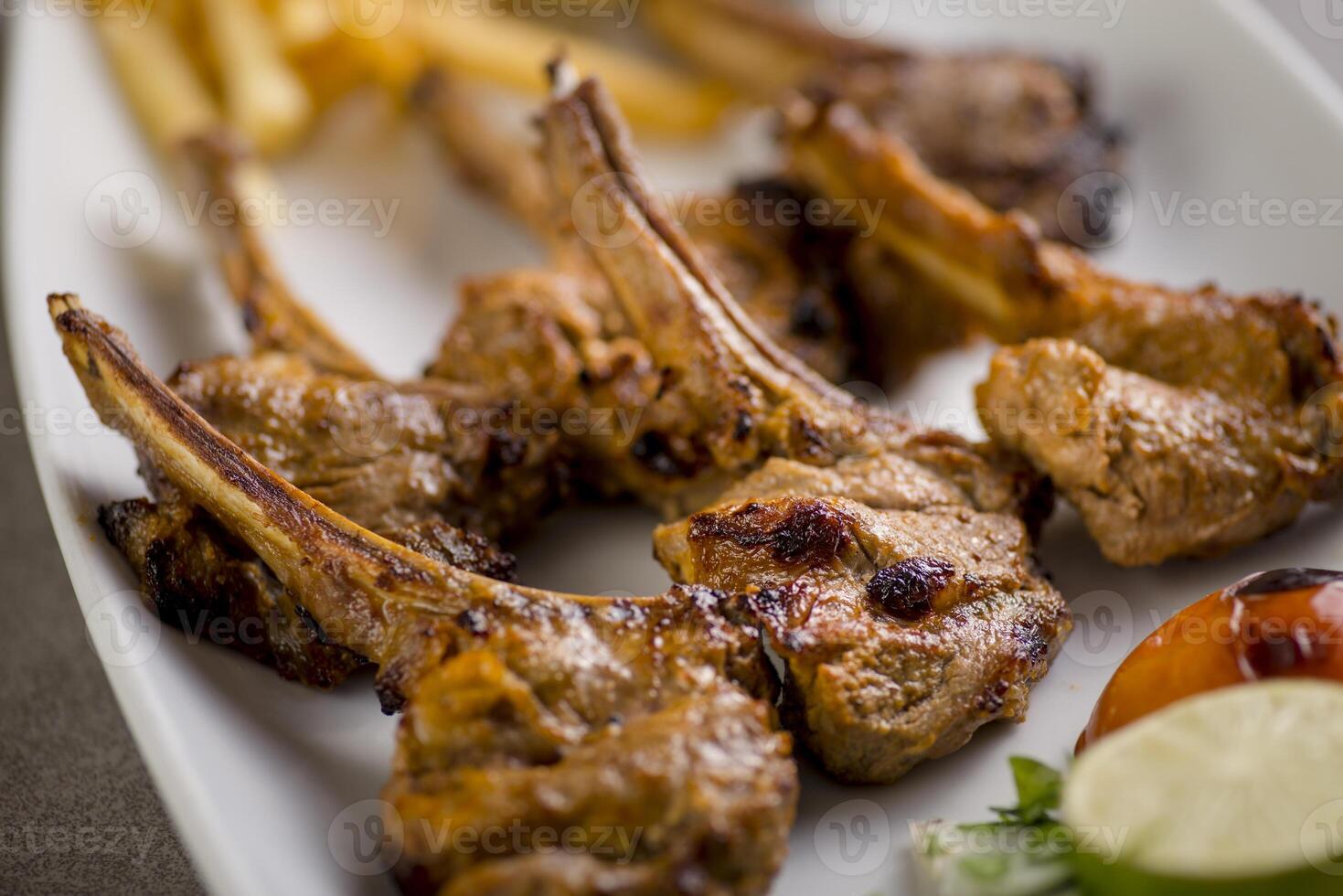 Spicy lamb chops served in dish isolated on grey background top view of arabic food photo