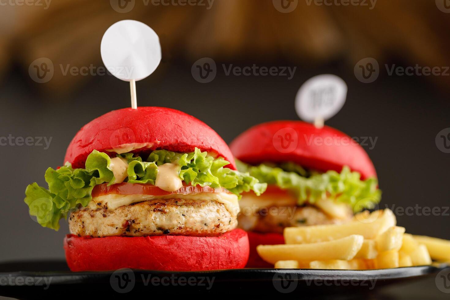 Mini chicken Burger with fries served in a dish isolated on grey background side view fast food photo