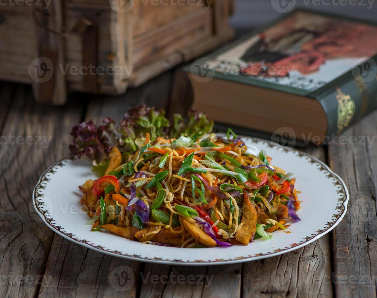 chinese chicken noodles served in a dish isolated on wooden background side view of noodles photo