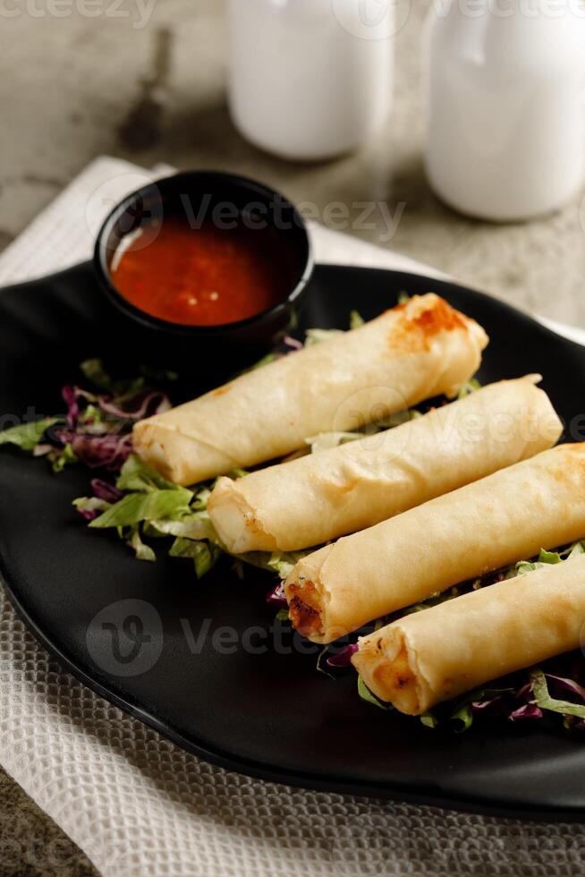 Vegetable Spring Roll with chili sauce served in a dish isolated on grey background side view fast food photo