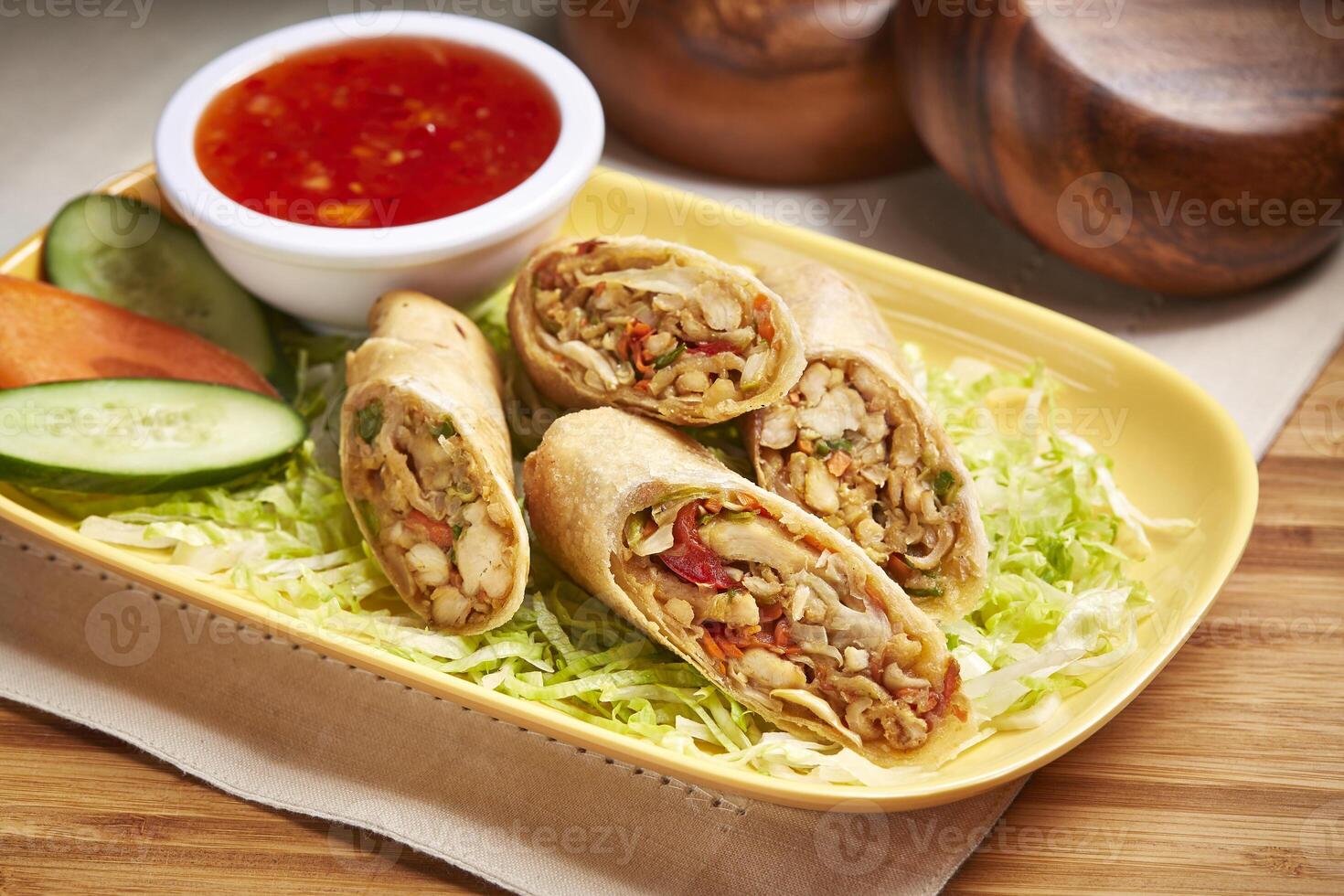 Vegetable Chicken Spring Rolls with chili sauce, salad and cucumber served in dish isolated on table side view of middle east food photo