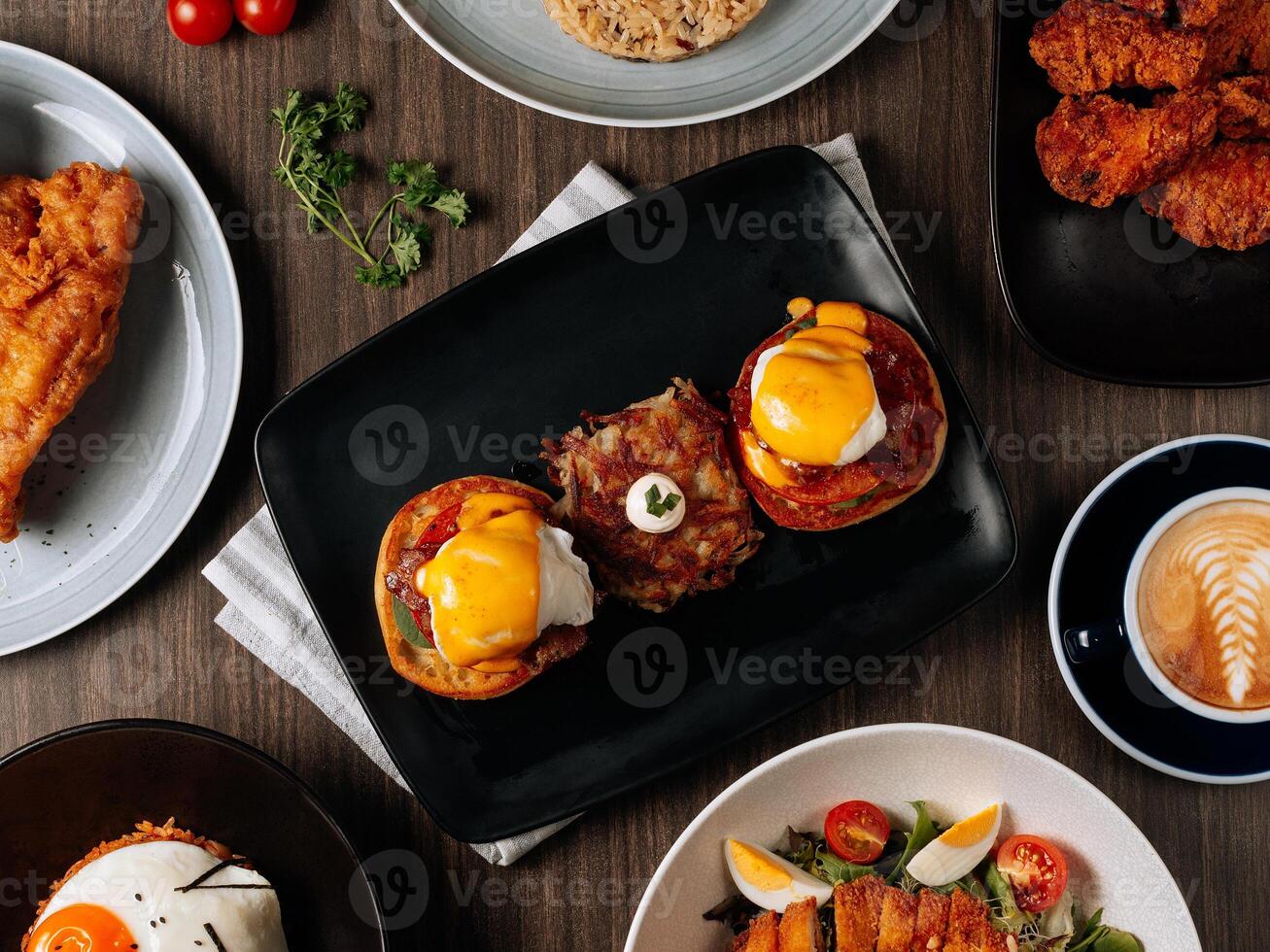 A breakfast fast food table Pan Fried Wild Cod Fish, Kimchi Fried Rice, Wing Zing, Fish And Chips, Caramel Latte, Eggs Blackstone, top view food photo