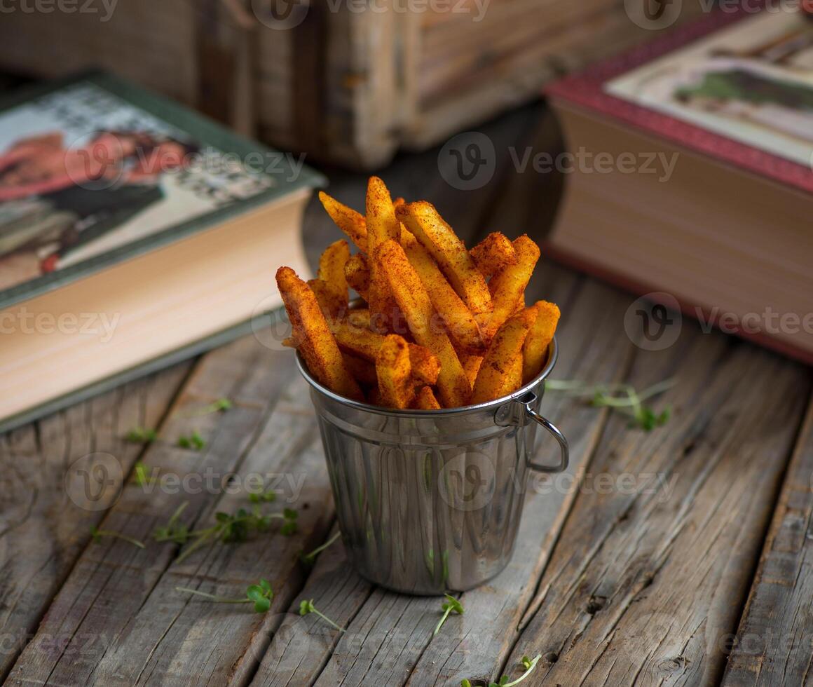 paprika fries served in a dish isolated on wooden background side view of appetizer photo