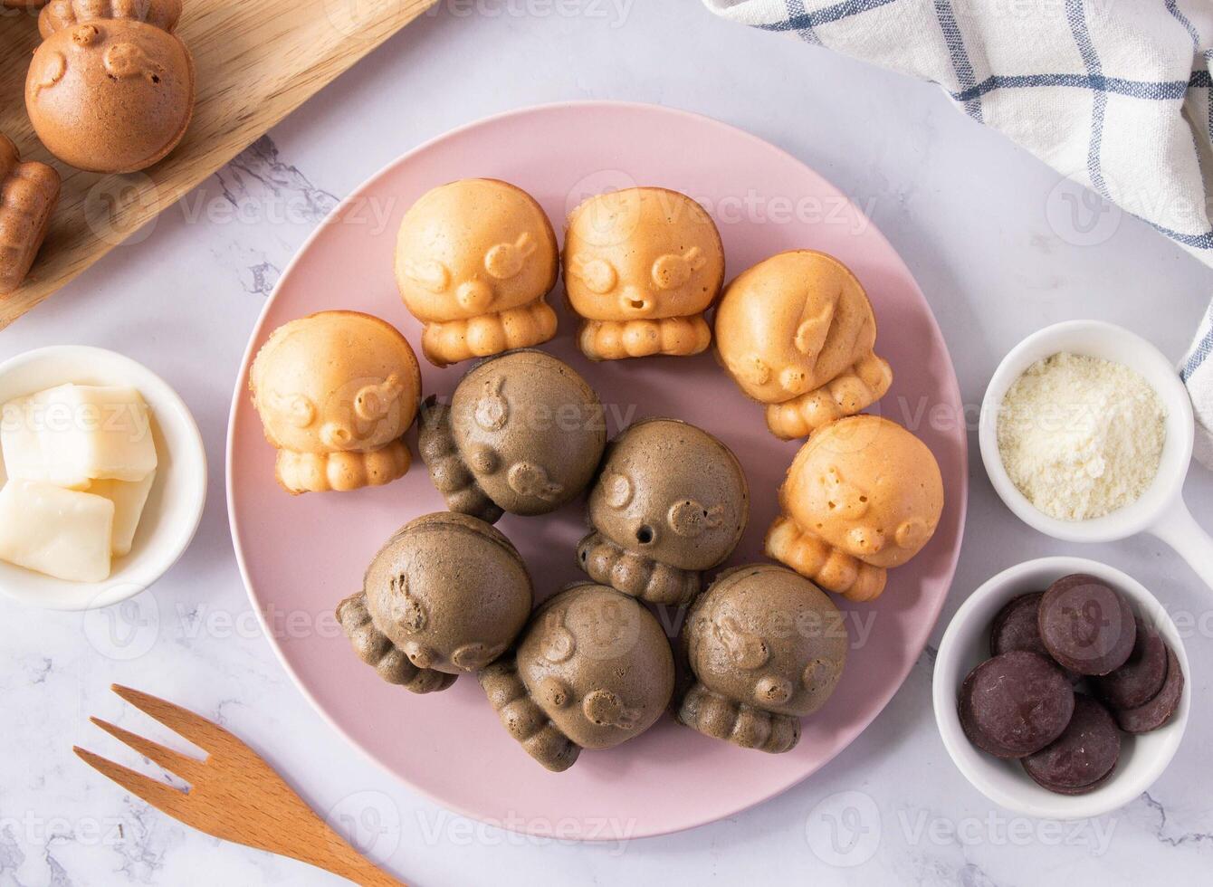 Bamboo Charcoal Wrapped Cheese, Red Quinoa Wrapped Cream Chicken Cake teddy bear shape in wooden plate on marble background photo