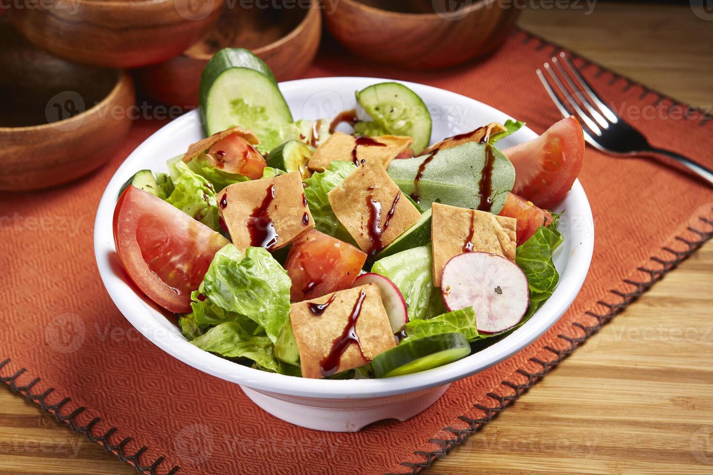 Fresh Fattoush Salad with tomato, cucumber and green leaf served in bowl isolated on table side view of middle east food photo