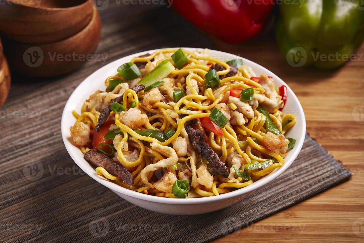 Mixed Noodles with vegetable, meat and chicken served in dish isolated on table side view of middle east food photo