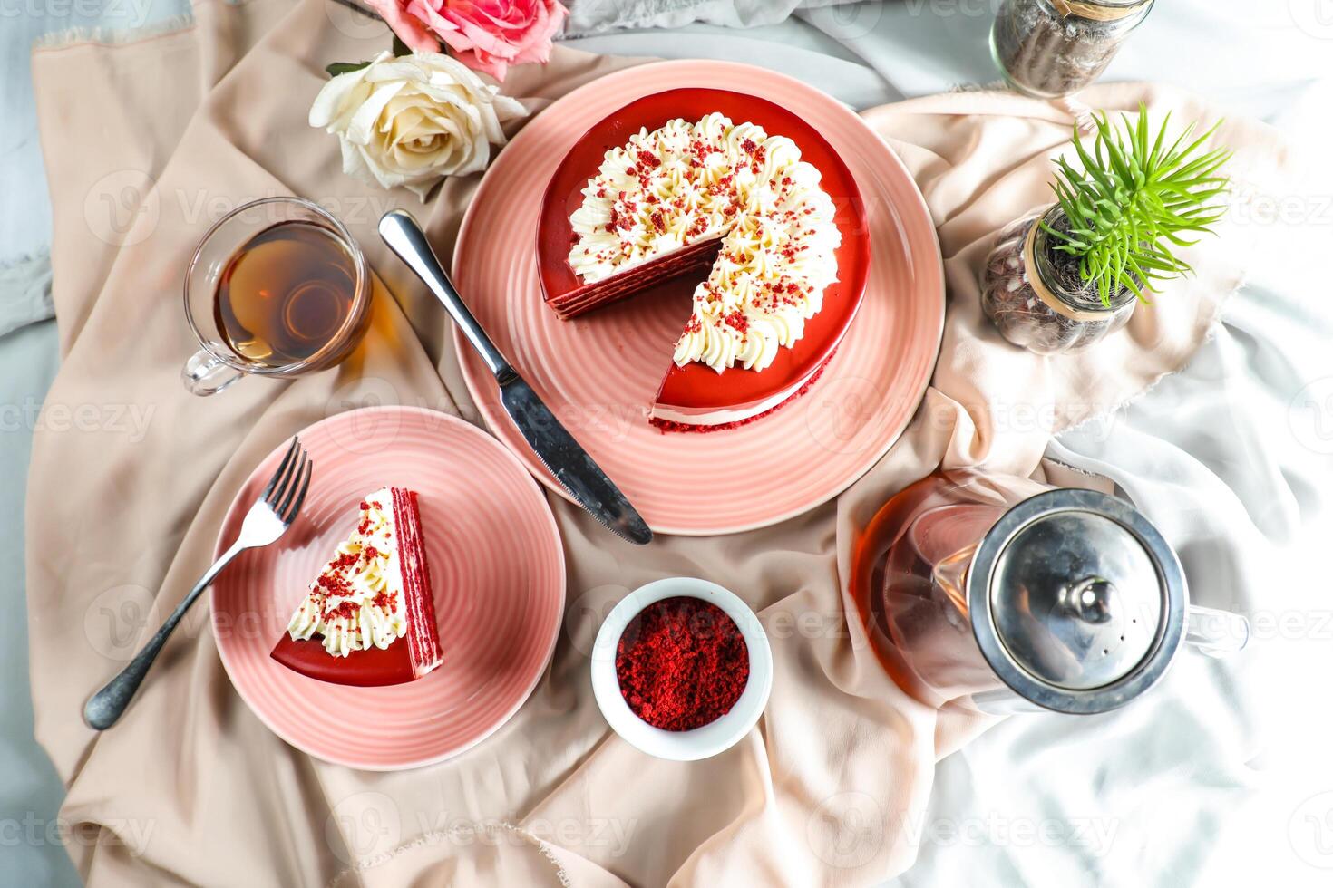 Premium Red Velvet cake and slice include cream, sugar with fork, cup of coffee and pot served on board isolated on napkin top view of cafe food photo