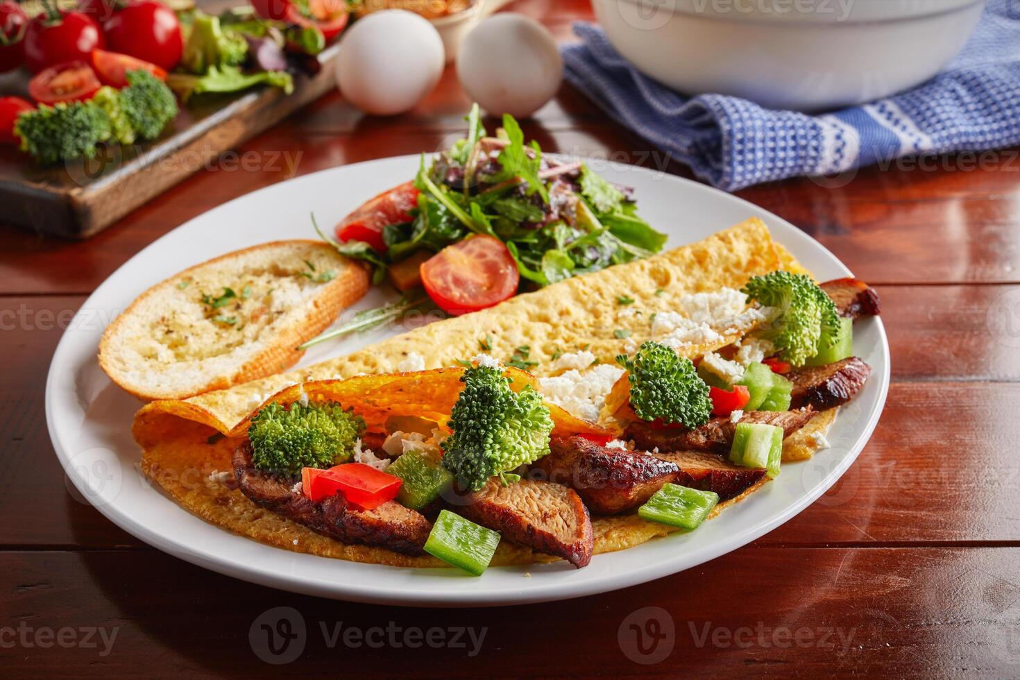 chicken omelette roll and salad served in a dish isolated on wooden background side view photo