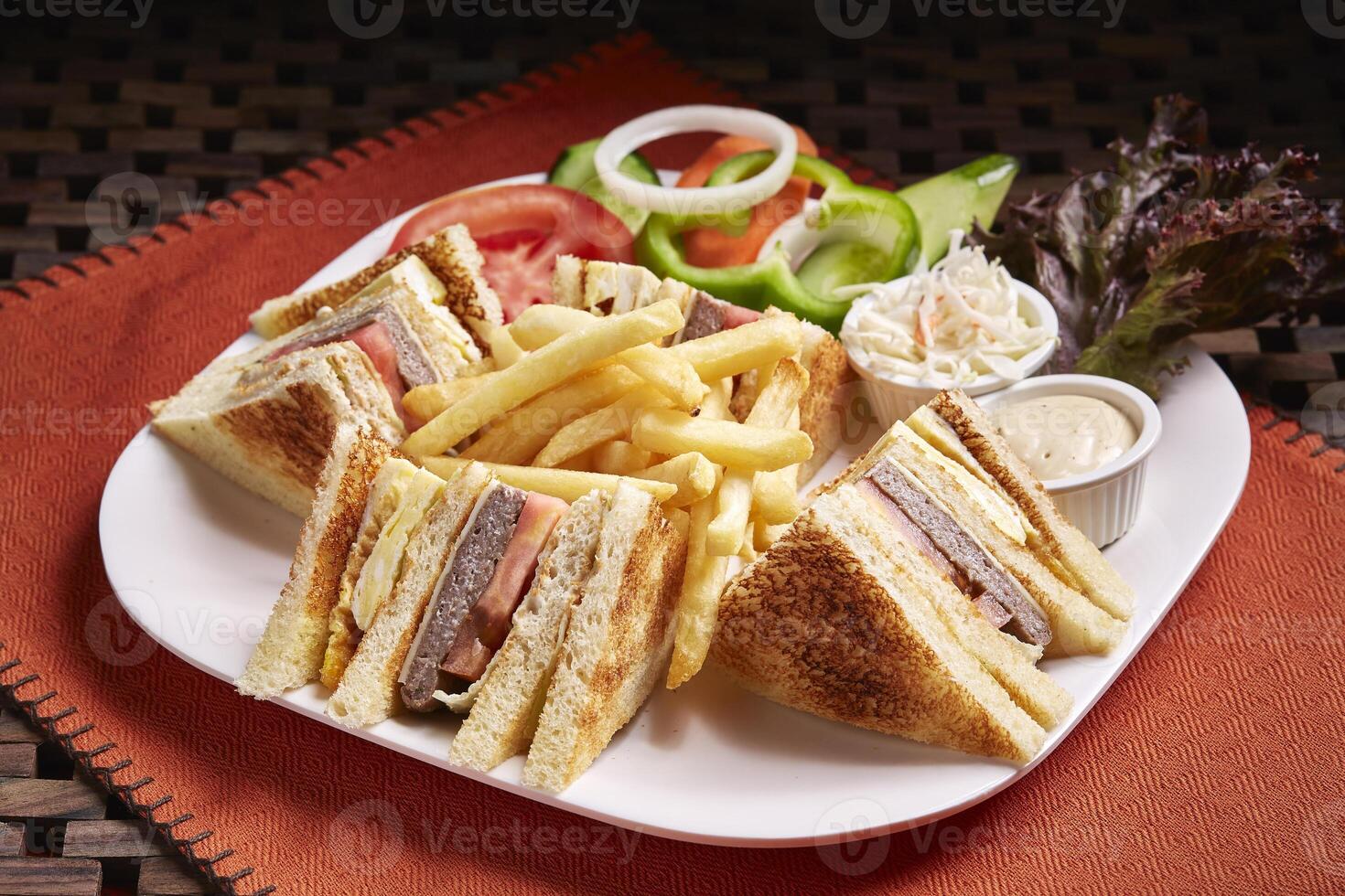 Club Sandwich with salad, fries and mayo dip served in dish isolated on table side view of middle east food photo