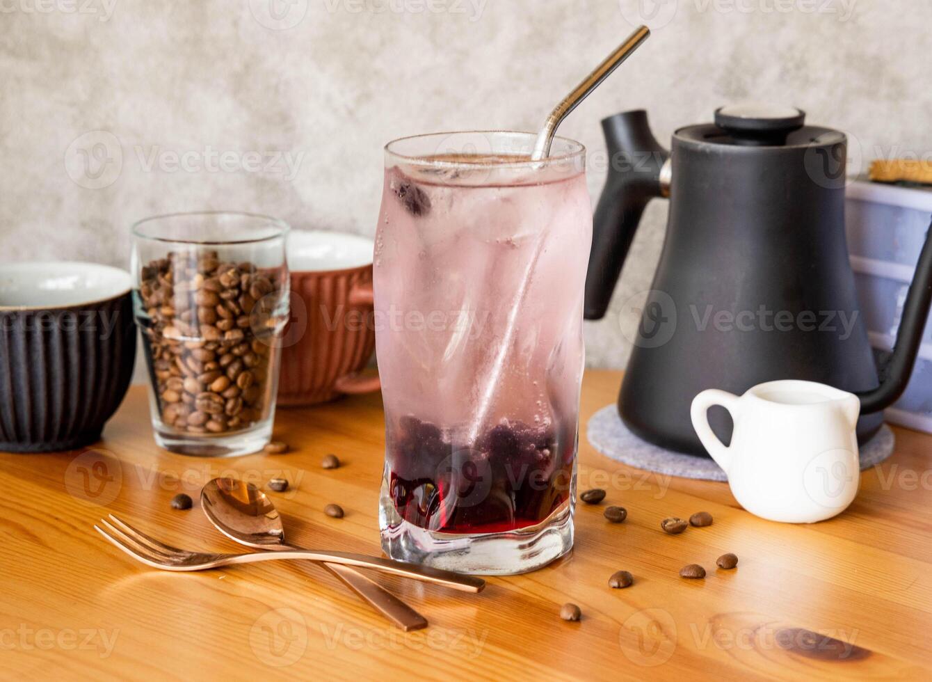 Glimmer Sparkling Drink with Cranberry with coffee beans, fork, spoon served in glass isolated on wooden table top view of taiwan food photo