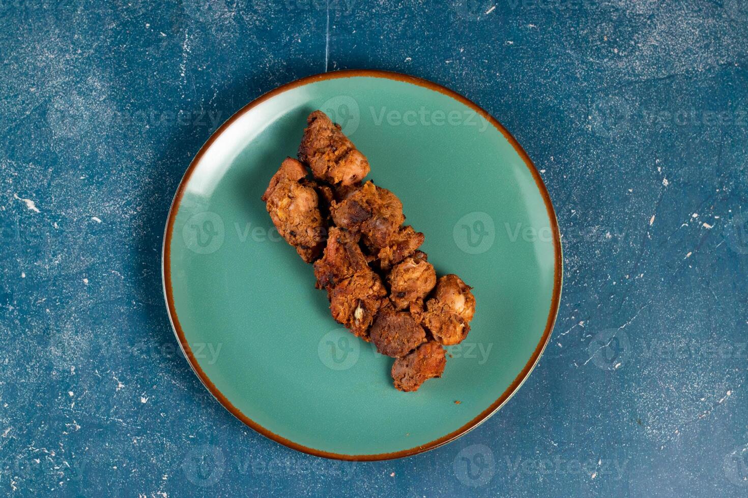 spicy bbq chicken tikka boti kabab served in a dish isolated on background top view photo