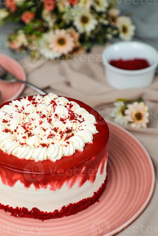 Premium Red Velvet cake include cream, sugar with fork, knife and flowers served in plate isolated on napkin side view of cafe food photo