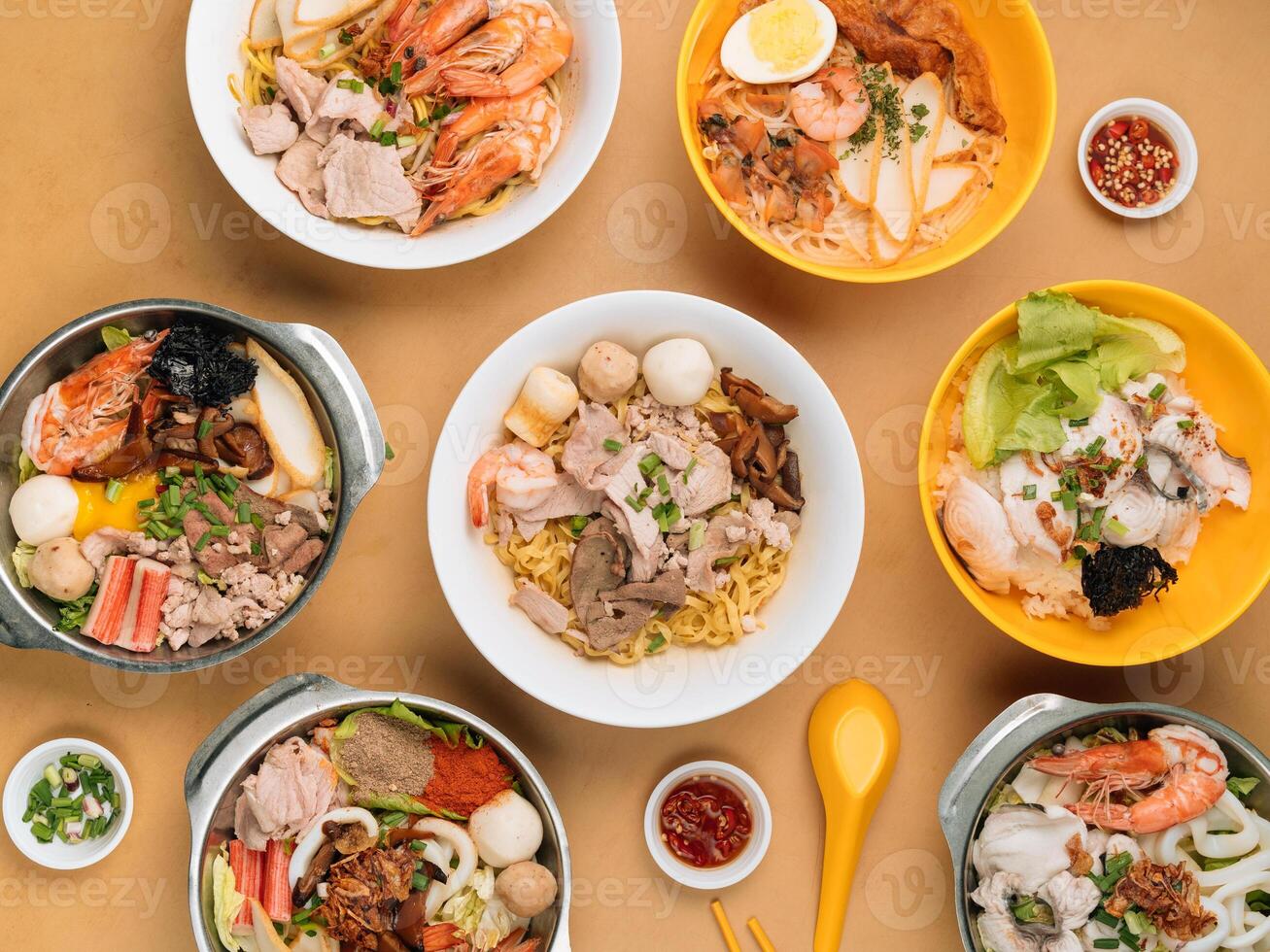 chinese seafood table with Tom Yum, Xiao Wan, Sliced Fish, Porridge, Bee Hoon, Black Soya Sauce, in a bowl with soup, chili sauce, spring onion top view on wooden table chinese seafood noodle table photo