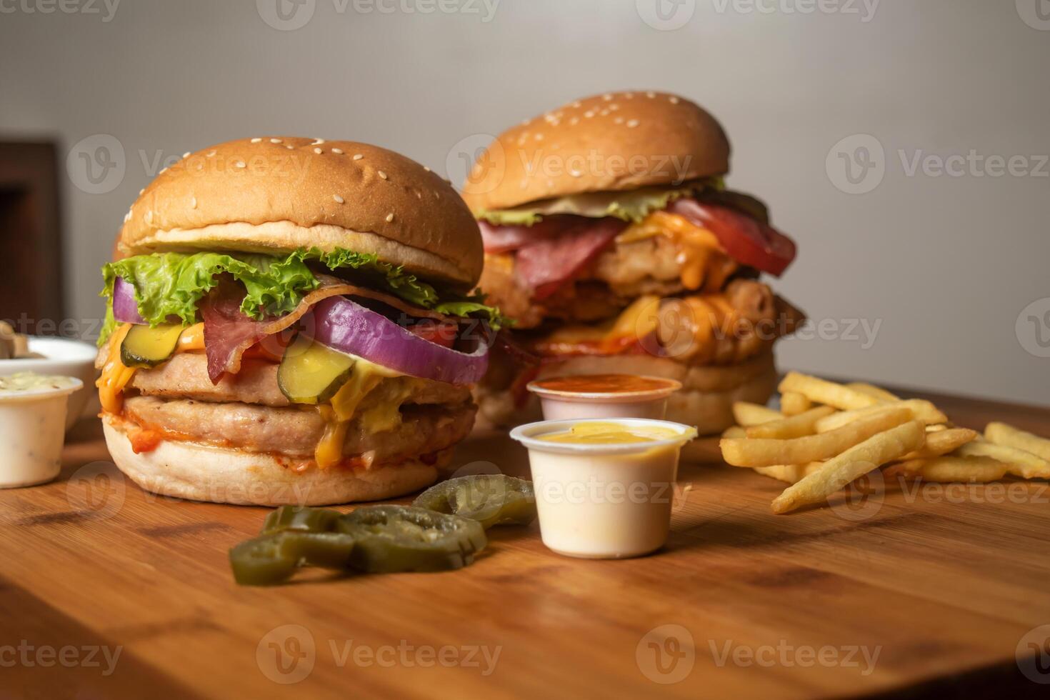 Assorted Burgers with Crispy Chicken Cheese burger with beef bacon isolated on wooden table top view of frech unhealthy fastfood photo