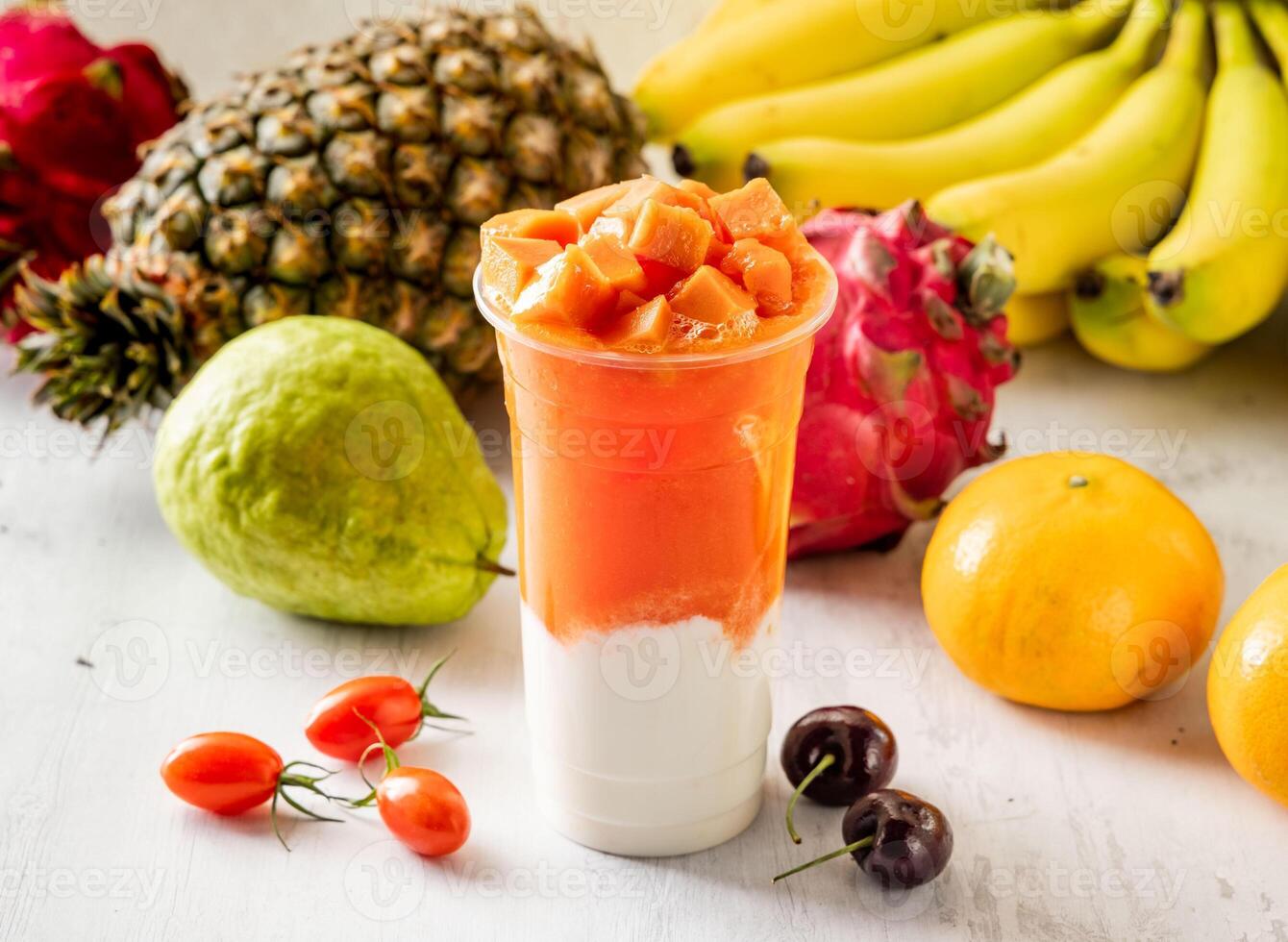 papaya milk with raw fruits served in disposable glass isolated on background top view taiwan food photo
