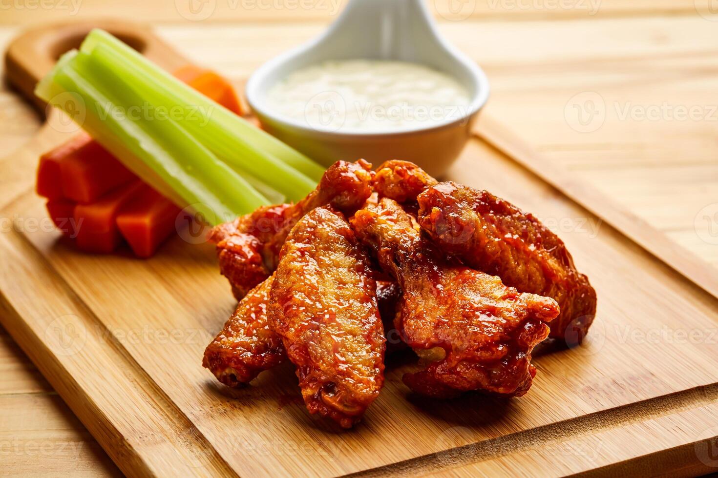 Buffalo Chicken wings with dip served in dish isolated on wooden table top view of starter fastfood appetizer food photo