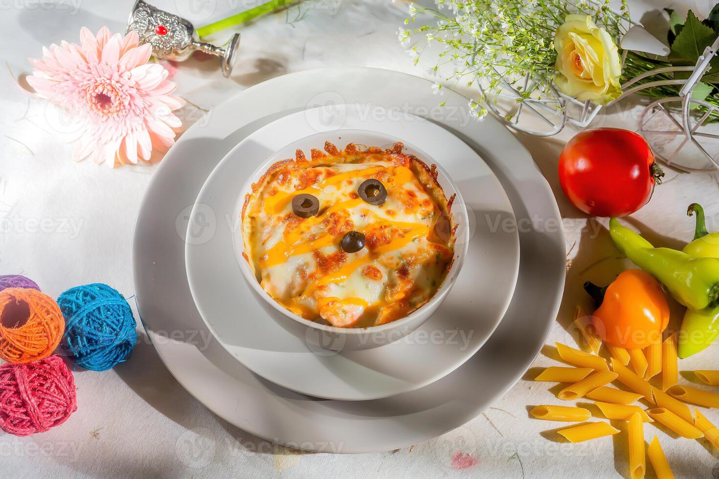 Fiery BBQ chicken Pasta with raw tomato in a bowl isolated on background side view photo