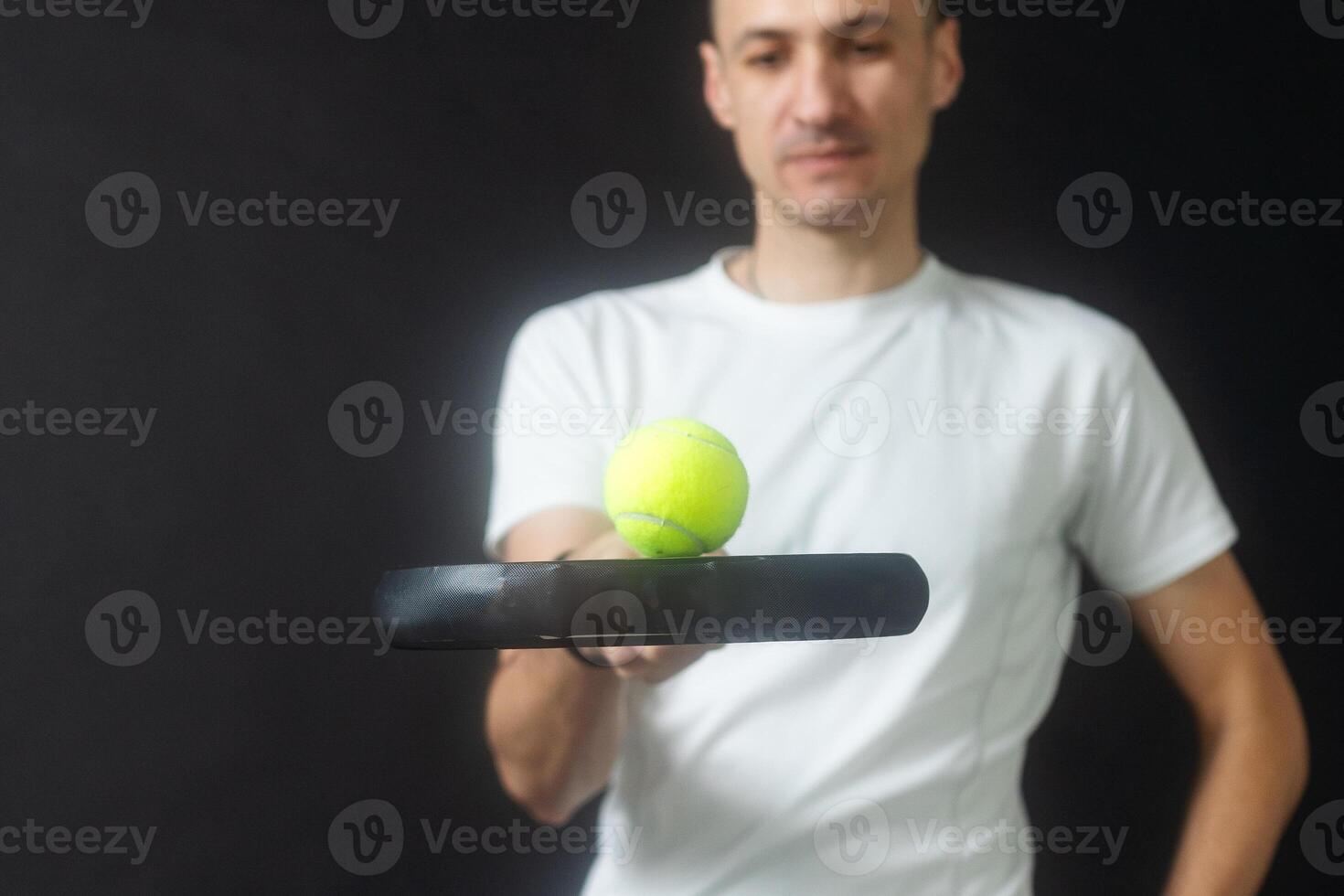 Paddle tennis player ready for serve on gray background photo