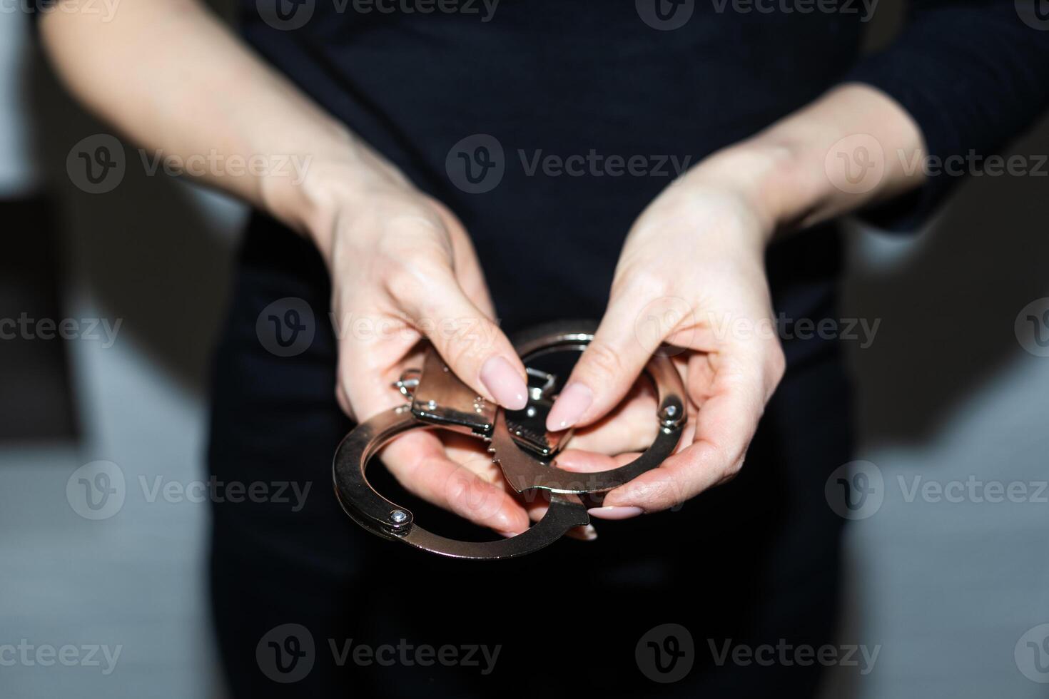 steel handcuffs of police special equipment, fetters on a black background photo