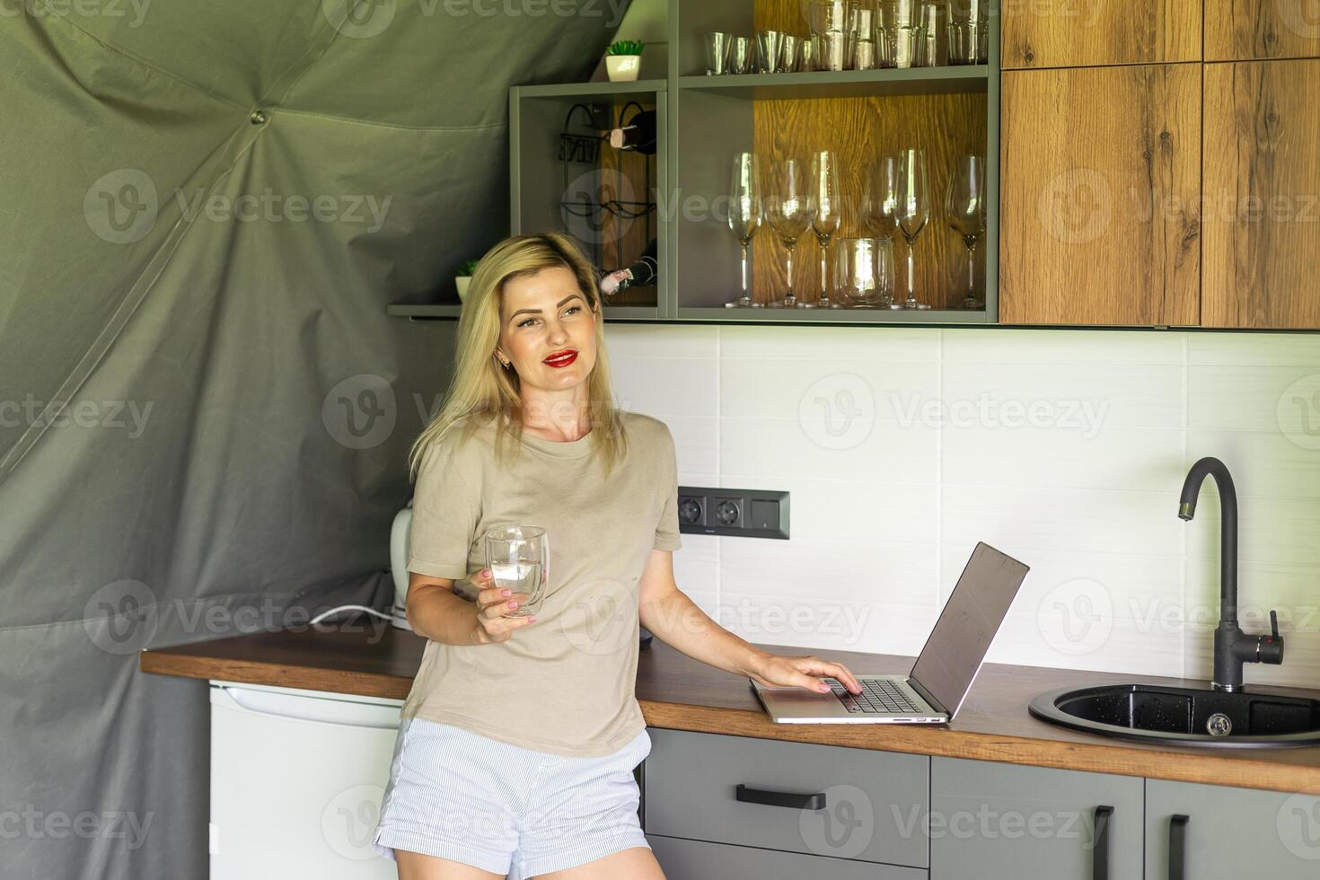 Joyful blonde girl smiling and talking via video call on laptop, home office, working remotely, explaining a strategy, freelancer, discussing a new project with team. photo