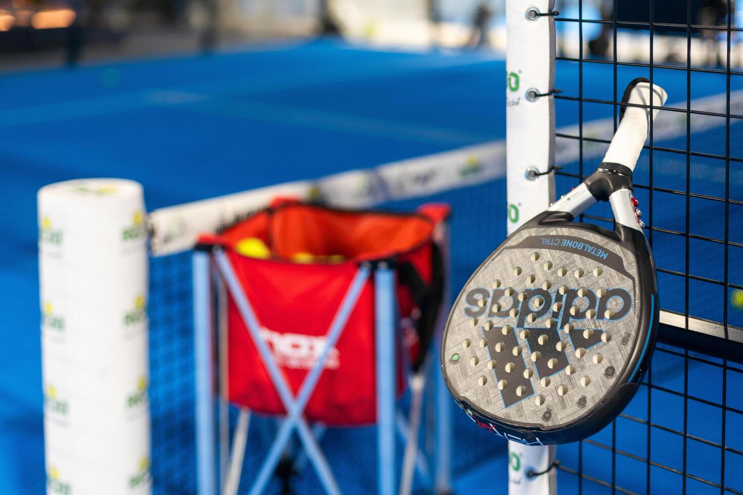 Kyiv, Ukraine. March 22, 2024 paddle tennis objects in court, racket, balls and fences photo