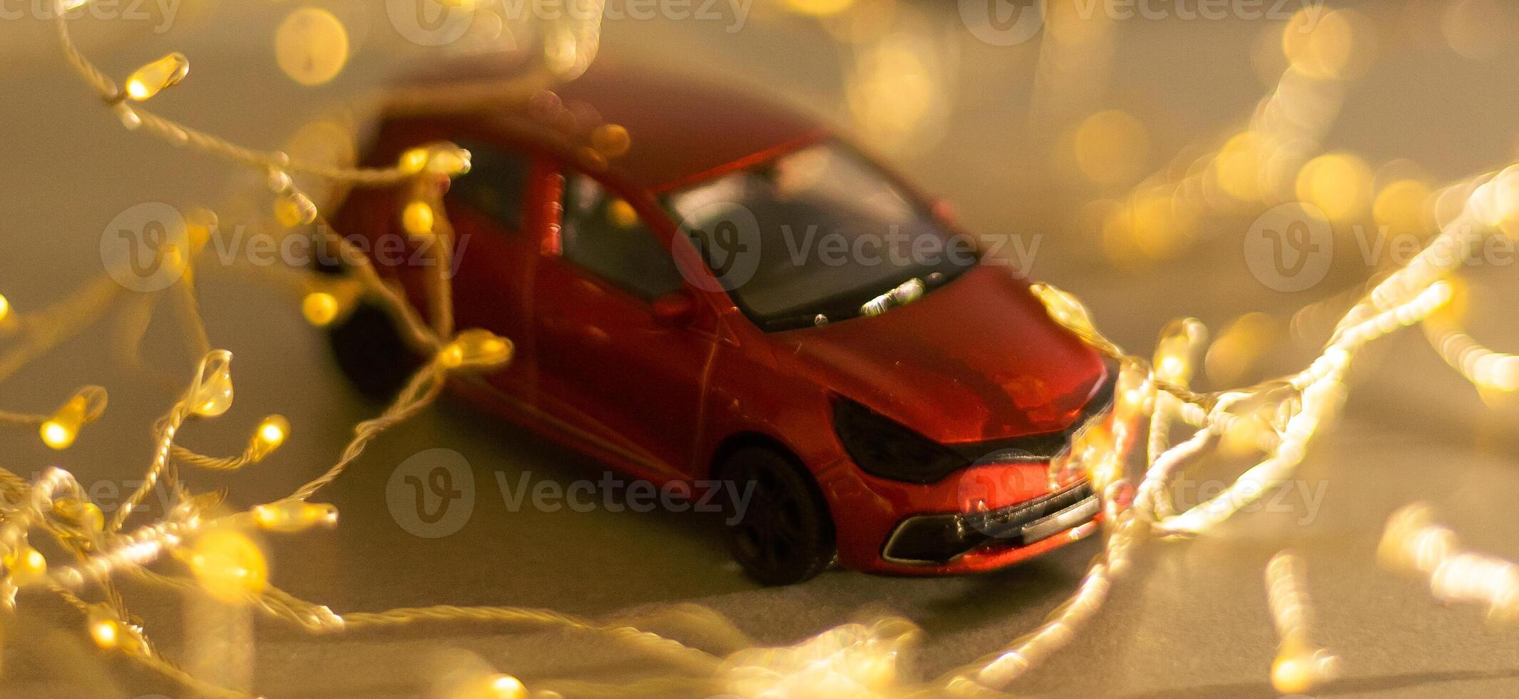 Miniature Car on colorful bokeh background. Holiday Merry Christmas concept. photo