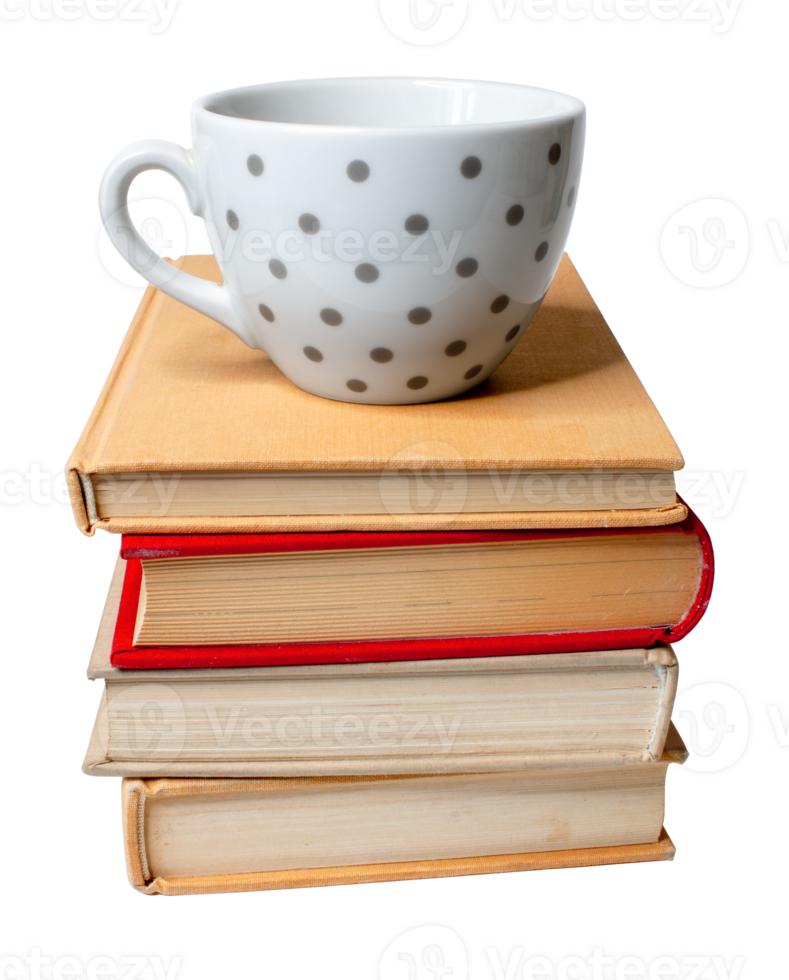 Empty dotted coffee cup placed on top of a pile of old books. png