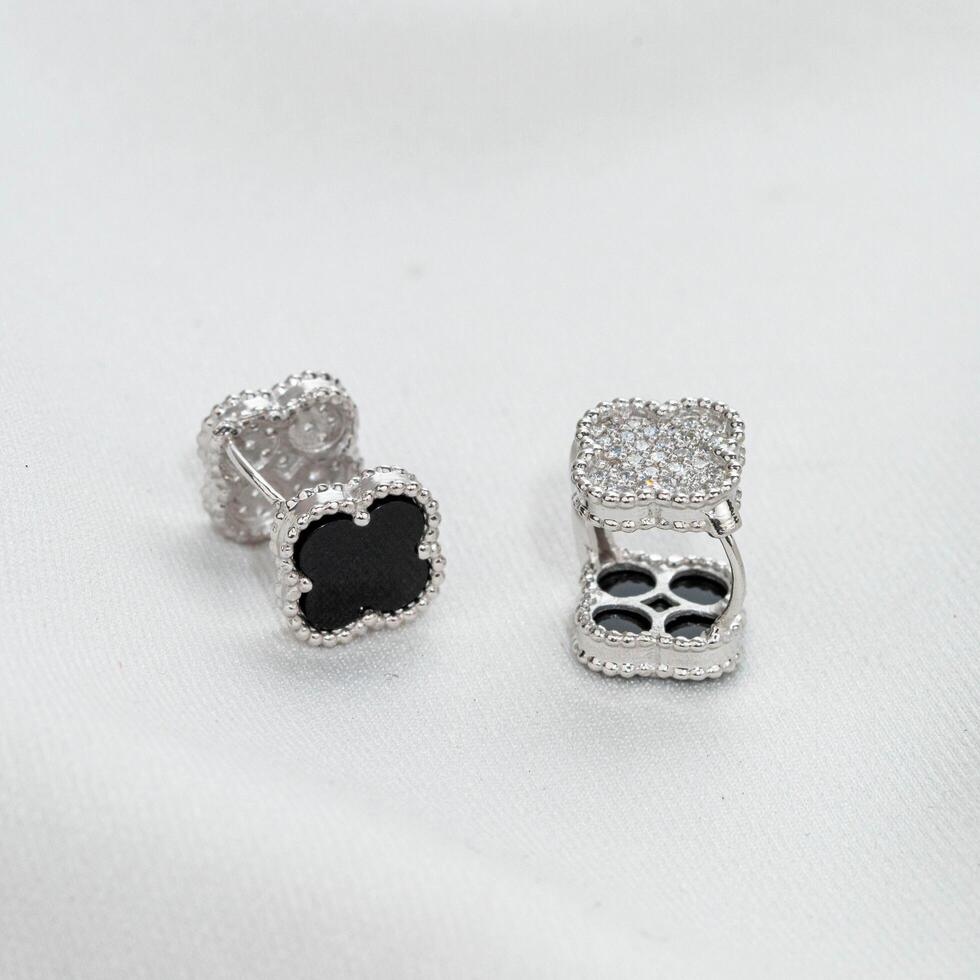 white gold earrings with black flowers photo