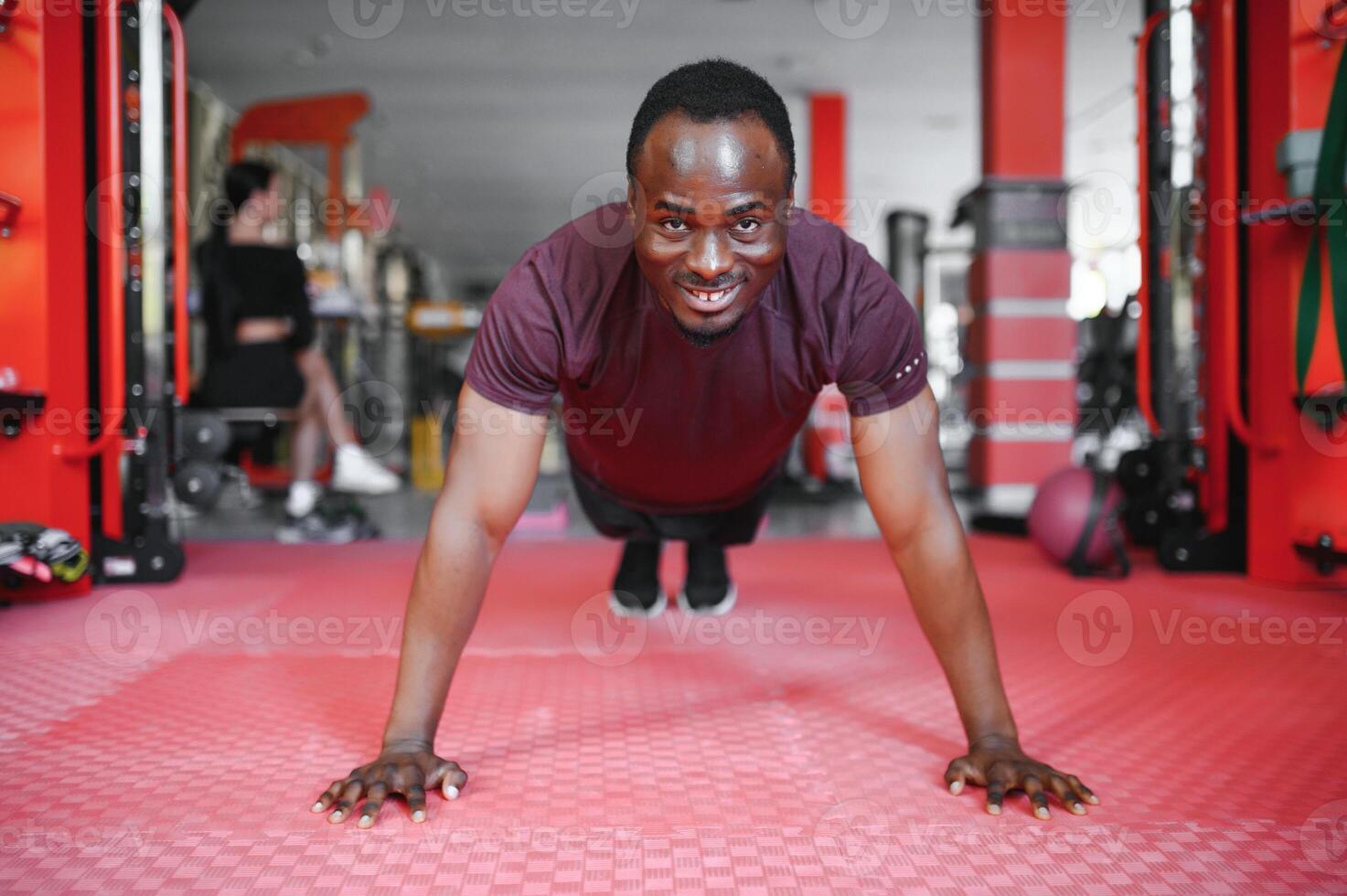Young athletic African American man in the gym photo