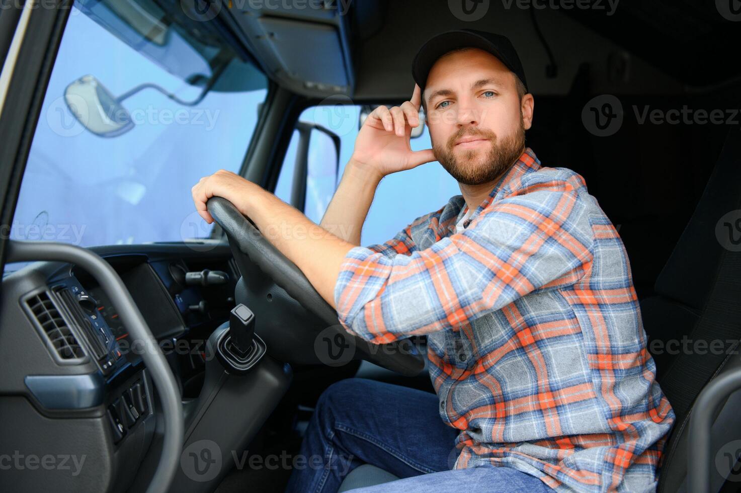 driver behind the wheel in truck cabin photo